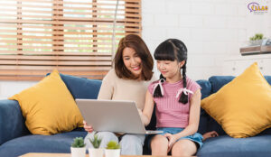 mother teaching her daughter to learn study online